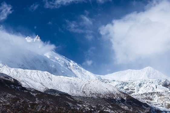 Mount Manaslu, 8163m, and Manaslu North, 7157m, in clouds on route from Sama (Samagaon) to Samdu in the Buri Gandaki Valley
