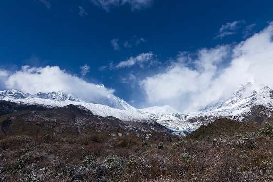 Mount Manaslu, 8163m, and Manaslu North, 7157m, in clouds on route from Sama (Samagaon) to Samdu in the Buri Gandaki Valley