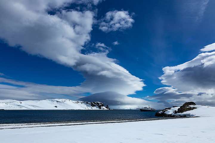 Lenticular clouds formed across Half Moon Bay, Half Moon Island, South Shetland Islands, Antarctica