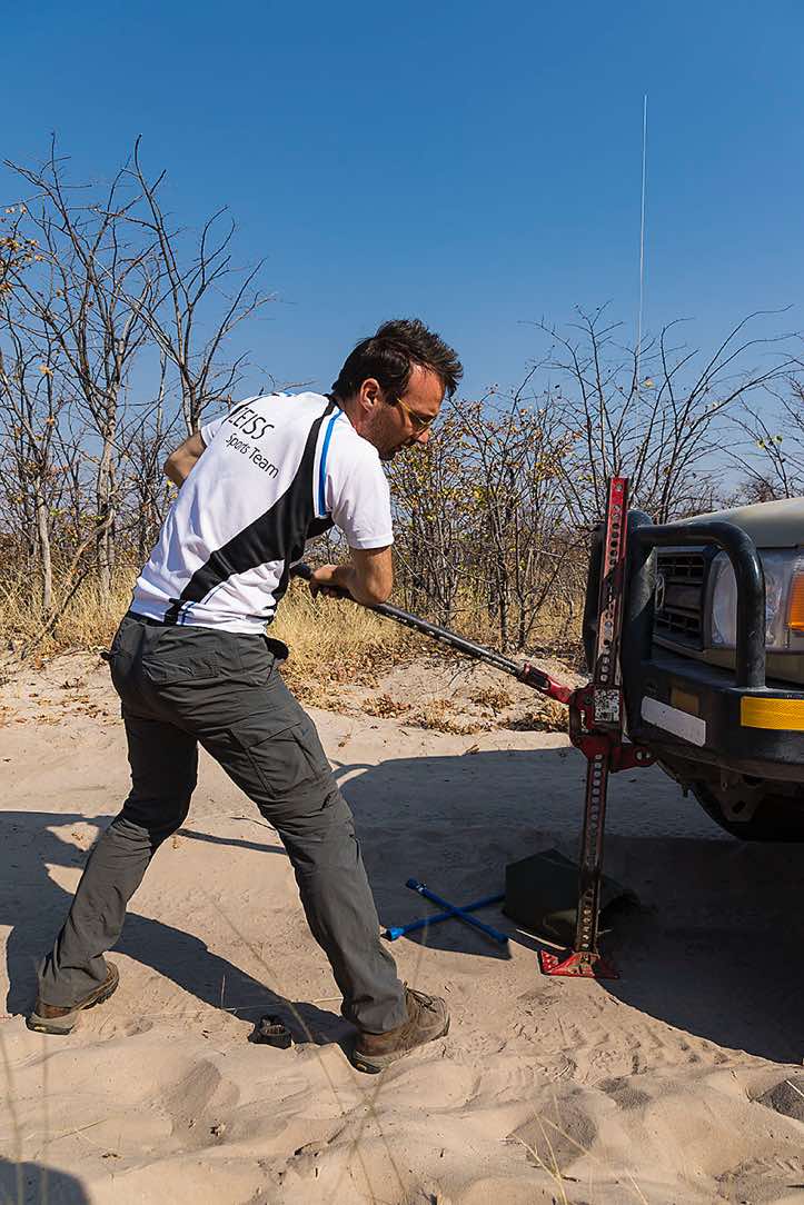 Using a jack to lift the car's axel