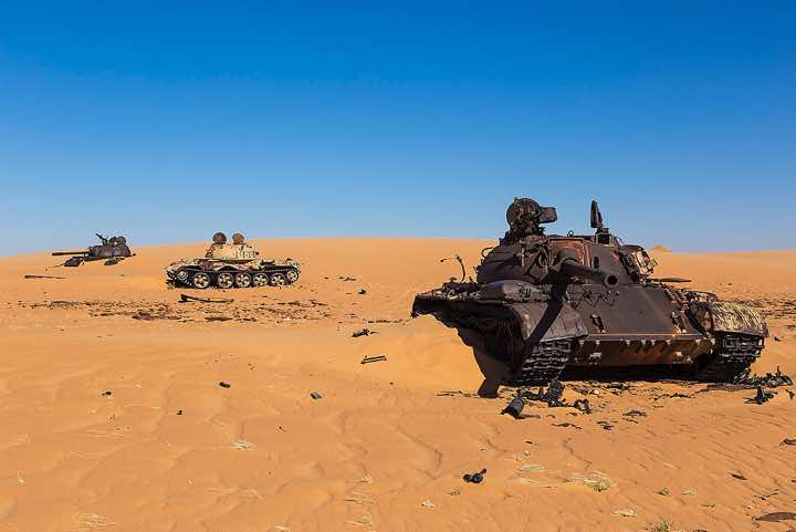 The remnants of Libyan tanks in the desert sand
