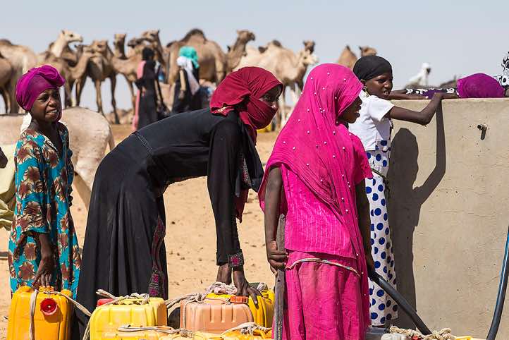 At a well nomads fill up their water canisters