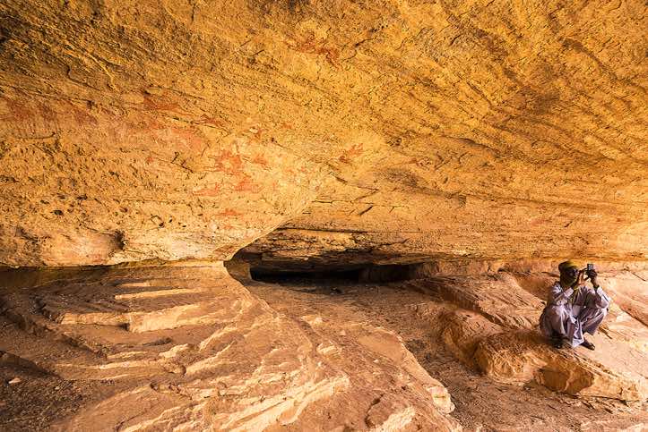 Local guide Haraoun with mobile phone at Terkei Cave, Ennedi Mountains, northeastern Chad