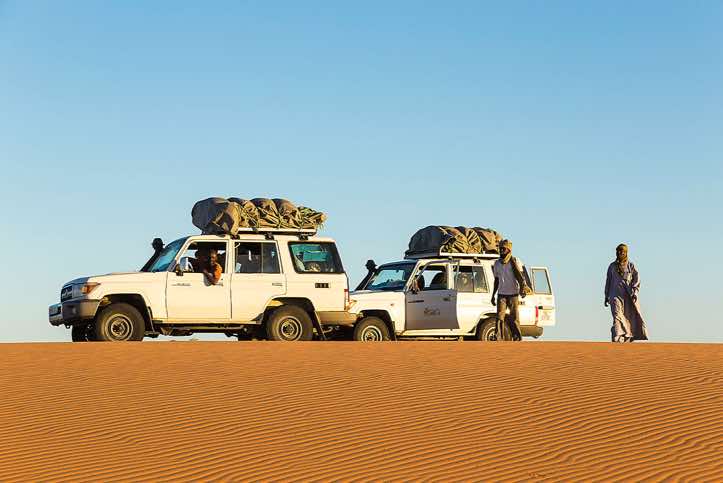 Off-road vehicles near desert campsite
