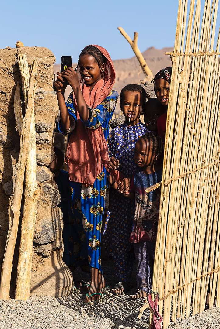 Tubu (Toubou) girl taking photographs, Yebbi Souma, Tibesti region