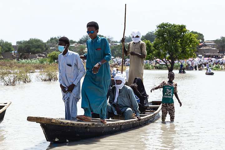 Wooden canoes are used to reach a village and it's marketplace on the opposite side of a lake