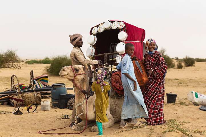 Nomadic family loading their camel at their campsite near Kouba Olanga, Borkou region