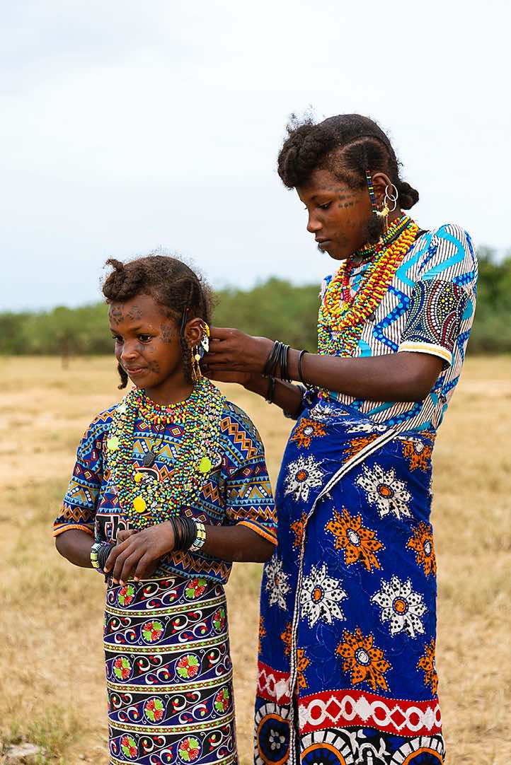 Wodaabe (Bororo) woman braiding a girls's hair at the Gerewol festival