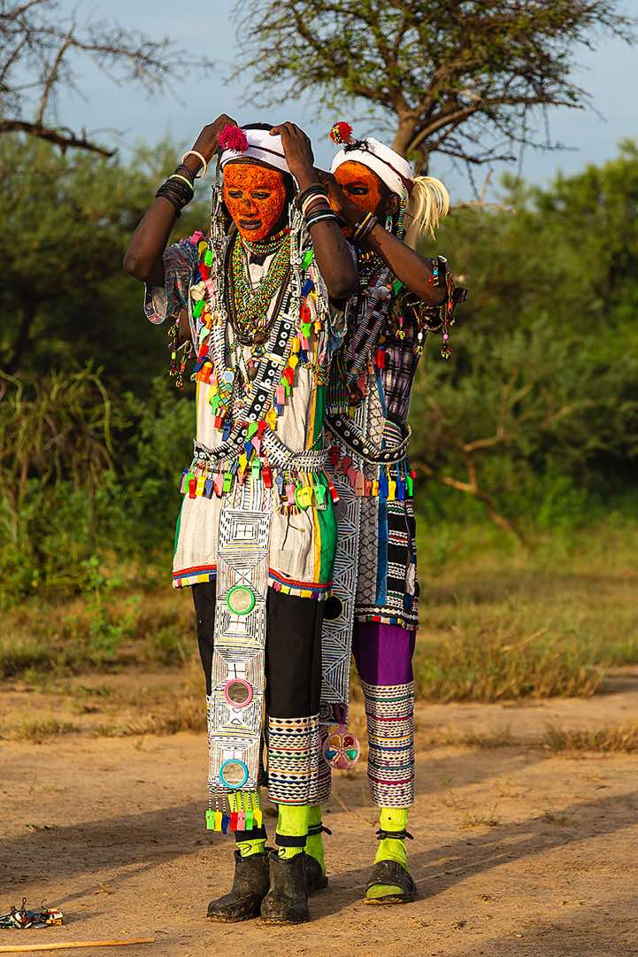 Wodaabe (Bororo) men helping each other to prepare for the Gerewol festival activitys