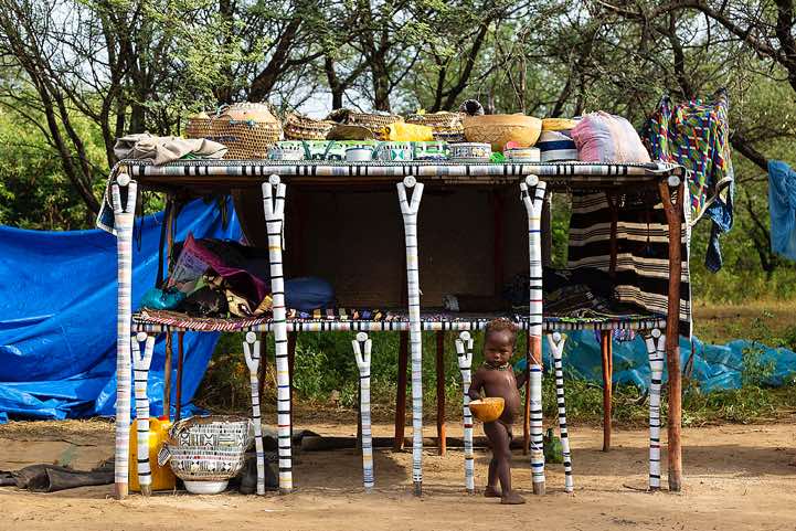 A large wooden bed constructed from brightly painted poles, set up from a Wodaabe (Bororo) family at the Gerewol festival campsite