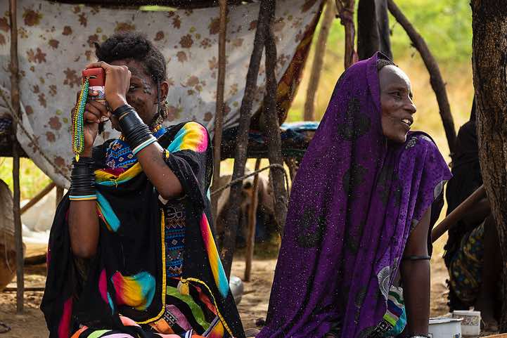 Wodaabe (Bororo) woman with mobile phone at campsite, Gerewol festival