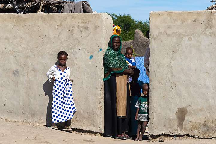 Woman and her kids in a small village