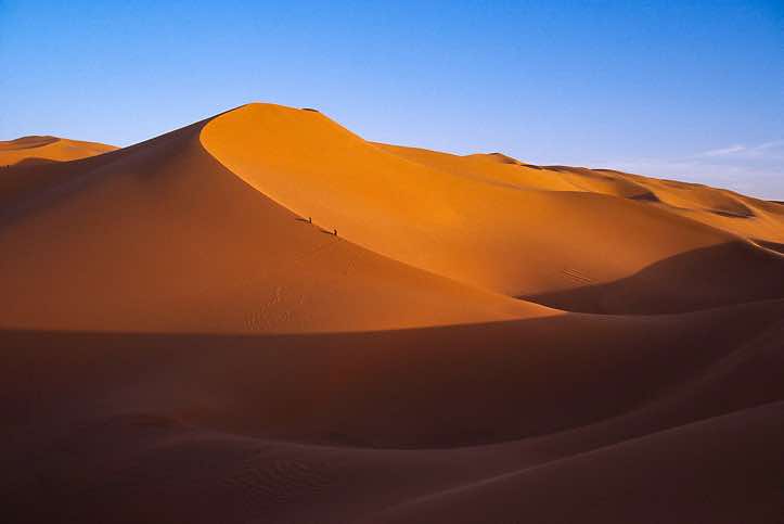 Dune ascent at sunset, near Ghat