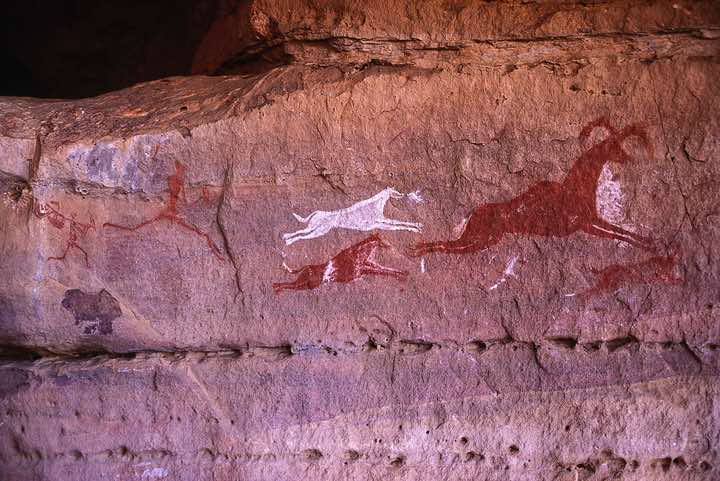 Hunting scene of men and dogs in hot pursuit of mouflons, Tin Taharit, Jabal Akakus