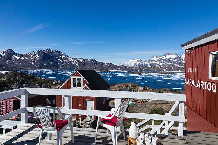 The edge of the Red House with its name in Greenlandic, overlooking the Tasiilaq Fjord, Ammassalik Island