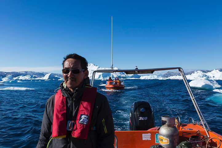Inuit steering the boat, Sermilik Fjord