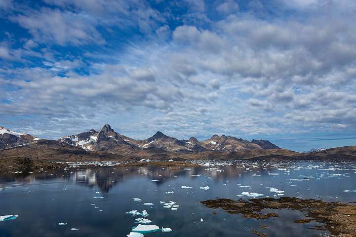 Mountains reflecting in water, Tasiilaq Fjord, Ammassalik Island