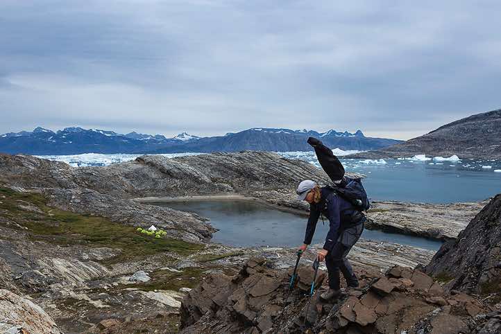 Guide Marijke van Langen near Tasilartik Fjord campsite with Sermilik Fjord in the background