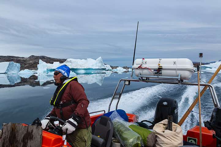 Inuit steering the boat, Sermilik Fjord