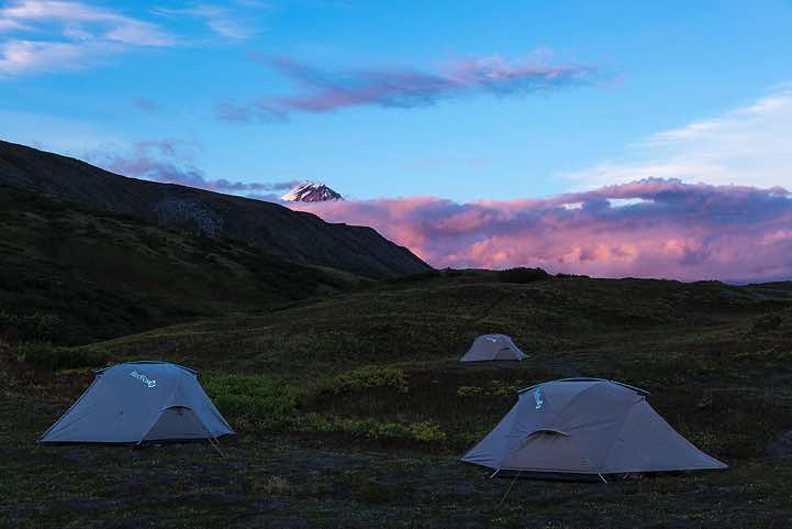 Campsite with top of Klyuchevskaya Sopka (or Klyuchevskoy) volcano, 4850m, in the background, around Tolbachik trek, Klyuchevskoy Nature Park