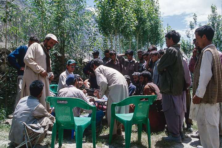 Porters receive their fixed payment, Hushe, Karakoram Mountains
