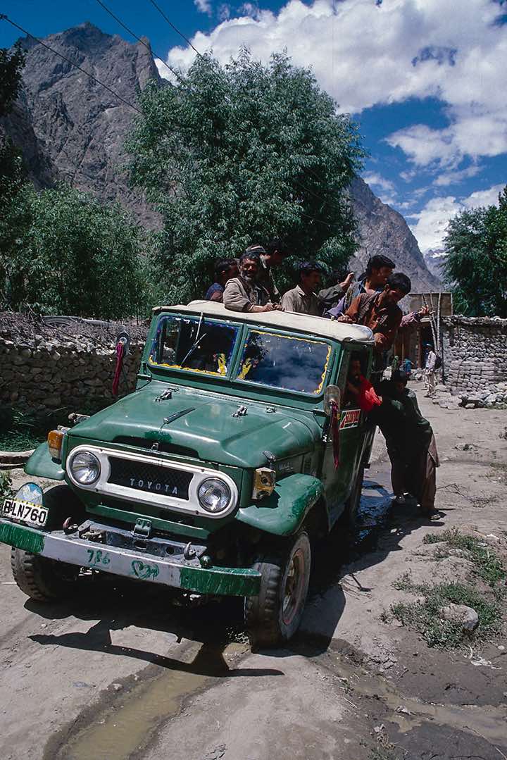 Porters wave goodbye at their departure, Hushe, Karakoram Mountains