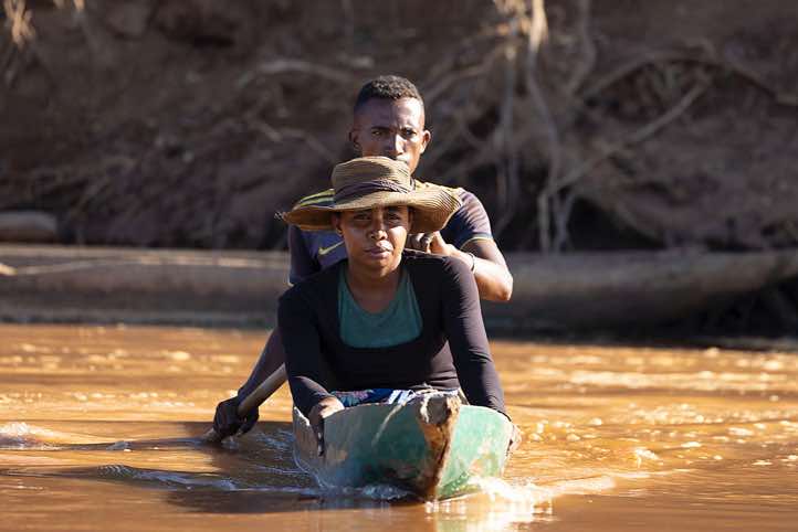 Couple in a wooden canoe on the Tsiribihina River, Western Madagascar