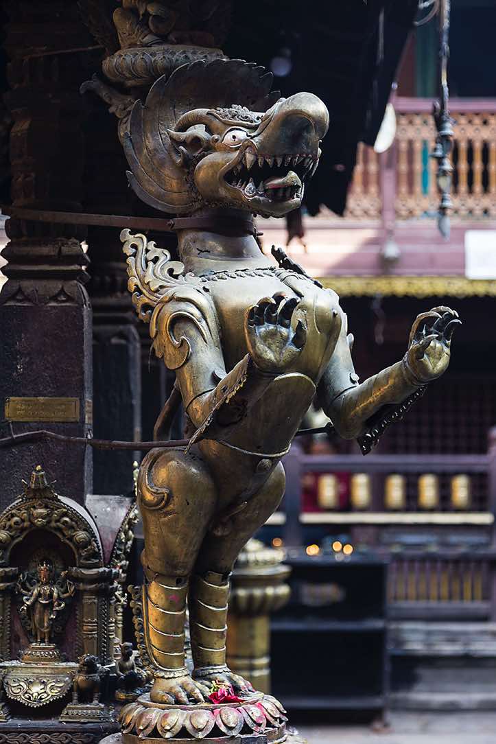 Gilt statue inside the courtyard of the Golden Temple, Patan