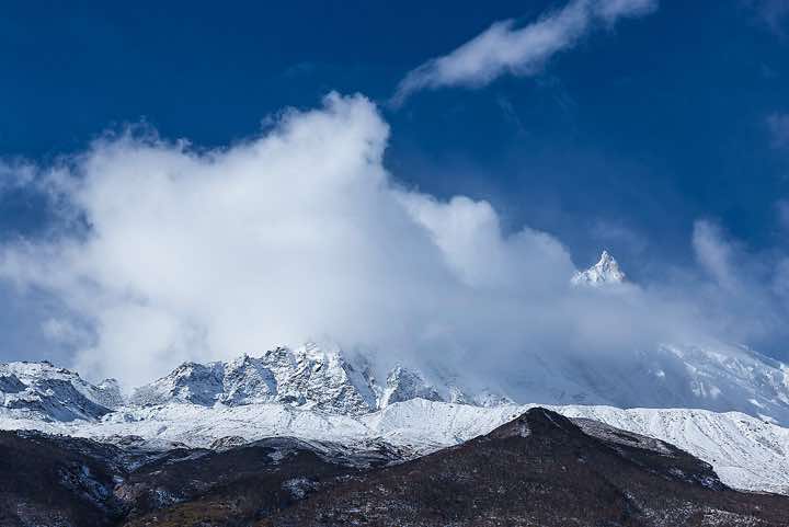 Mount Manaslu, 8163m, in clouds on route from Sama (Samagaon) to Samdu in the Buri Gandaki Valley