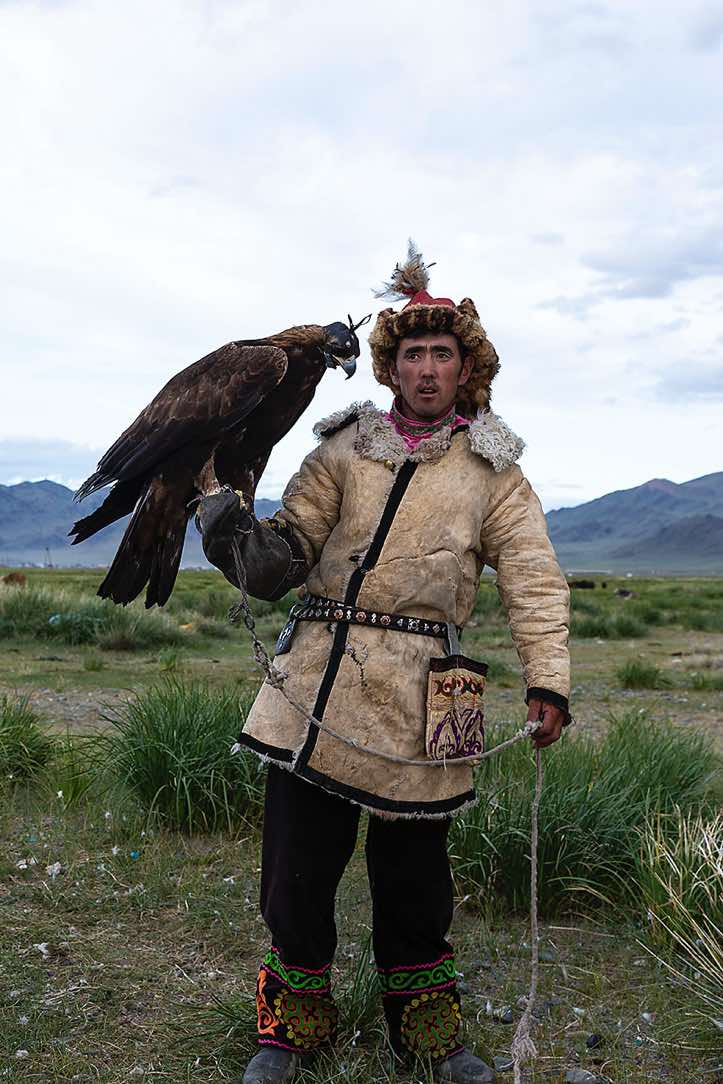 Eagle hunter dressed in traditional cloth, Altai Mountains, Western Mongolia