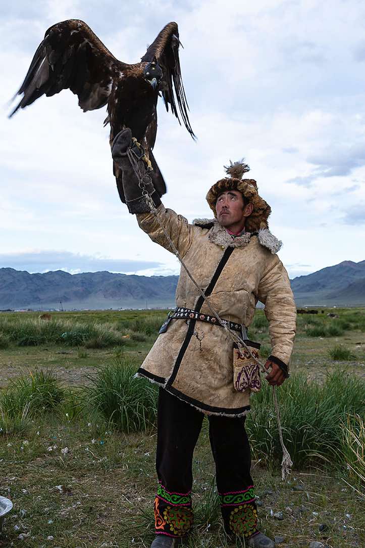 Eagle hunter dressed in traditional cloth, Altai Mountains, Western Mongolia