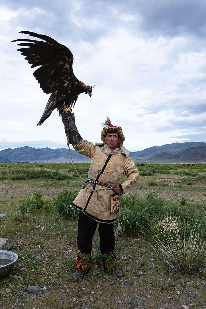 Eagle hunter dressed in traditional cloth, Altai Mountains, Western Mongolia