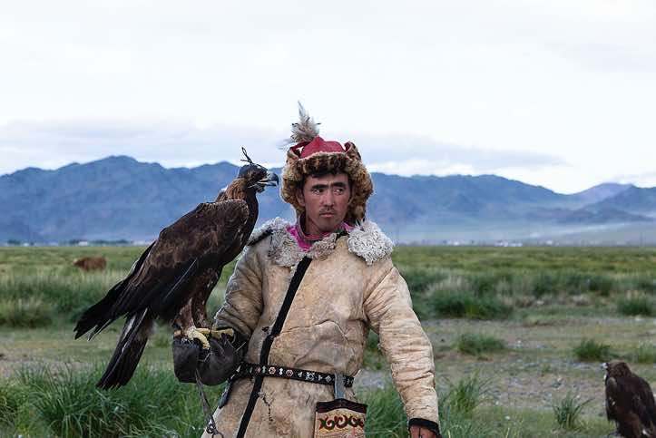 Eagle hunter dressed in traditional cloth, Altai Mountains, Western Mongolia