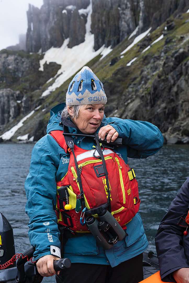 Expedition guide Ursula Tscherter steering the zodiac at the bird cliffs of Alkefjellet, Hinlopen Strait