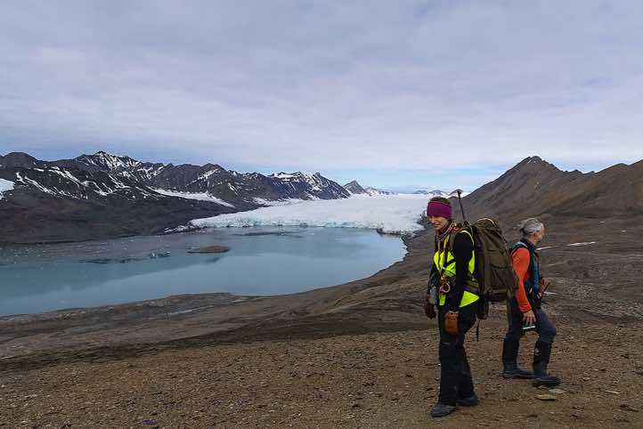 Assistant expedition guide Chloé Maréchal and expedition leader Philipp Schaudy on top of Valentinryggen mountain ridge, St. Jonsfjorden, Oscar II Land