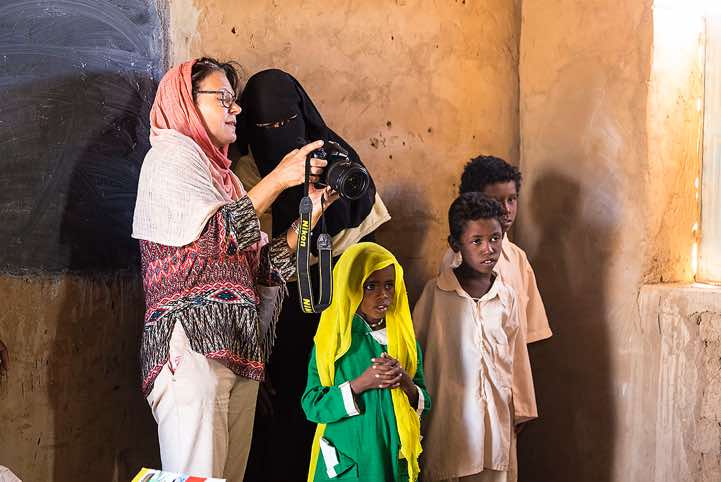 Local teacher, pupils and Austrian guide Karin Scheidhammer at school, Bayuda Desert, Northern Sudan