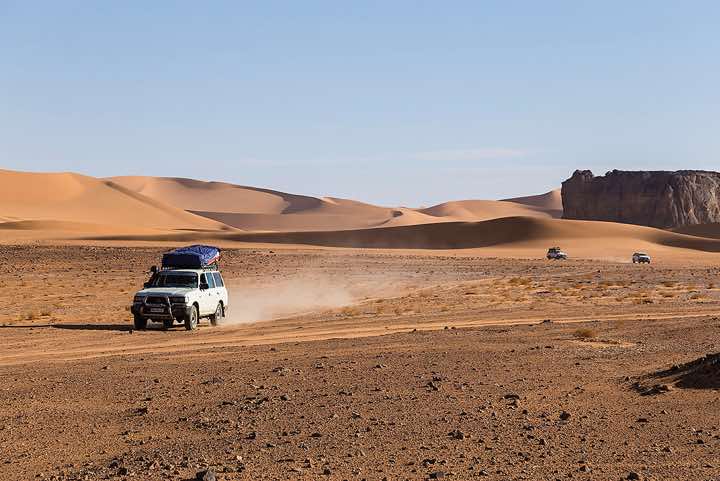 Four-wheel vehicle near Moul Naga dunes, Tadrart region, Tassili n' Ajjer National Park, Sahara, North Africa