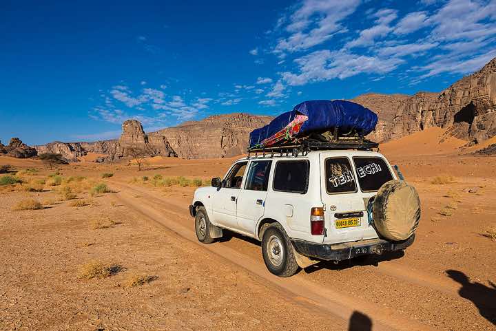 Four-wheel vehicle near Moul Naga dunes, Tadrart region, Tassili n' Ajjer National Park, Sahara, North Africa