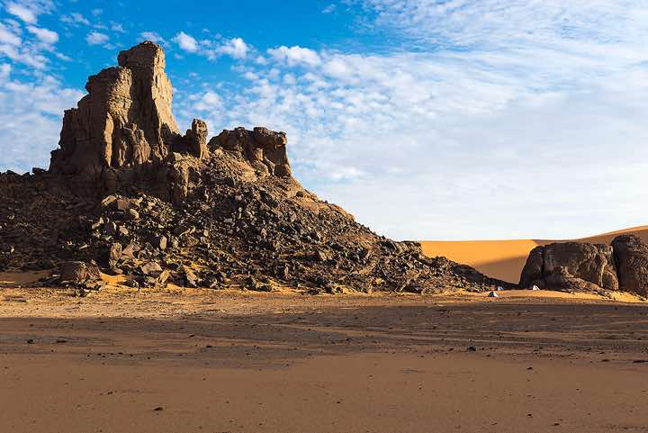 Campsite at rock formation, Ouan Zaouatan, Tadrart region, Tassili n ́Ajjer National Park, Sahara, North Africa