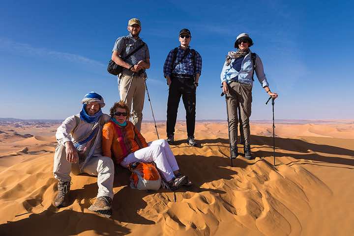 Group on top of a tall sand dune, southern Oued In Tehak, Tadrart region, Tassili n ́Ajjer National Park, Sahara, North Africa