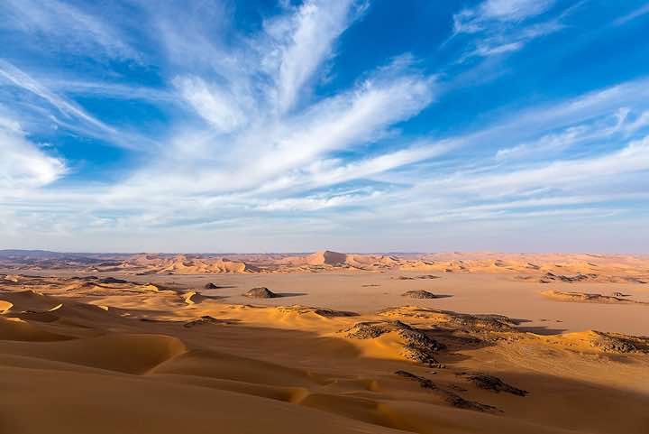 Claypan or playa and sand dunes of Oued In Djerane, Tadrart region, Tassili n ́Ajjer National Park, Sahara, North Africa