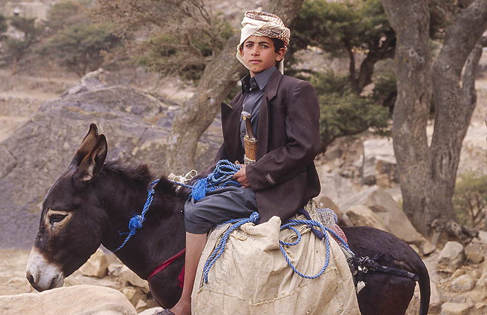 Boy on a donkey proudly wears his jambiya, Yemen